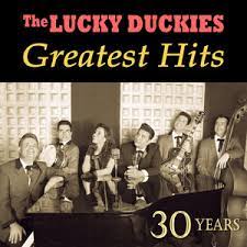 Album cover of The Lucky Duckies Greatest Hits featuring Las Vegas guitar lessons and the song Buona Sera