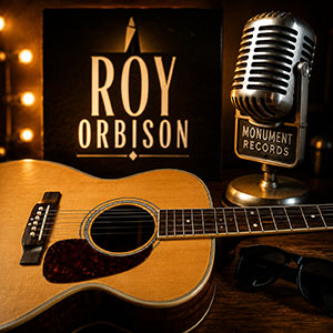 Roy Orbison guitar lessons featuring acoustic guitar and classic Monument Records imagery Roy Orbison guitar lessons featuring acoustic guitar and classic Monument Records imagery
