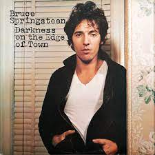 Album cover for 'Darkness On The Edge Of Town' album featuring the song 'The Promised Land' by Bruce Springsteen – Learn to play on guitar.